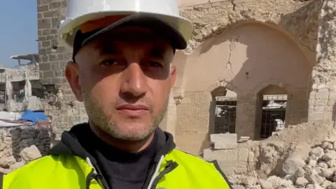 Hamouda al-Dahdar stands in front of the ruins of the Pasha's Palace in Gaza City, northern Gaza