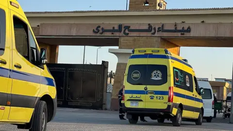Ambulances wait in line at the Egyptian side of the Rafah border crossing with the Gaza Strip (2 February 2026)