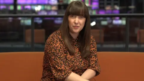 Nicola Bryan, who has long brown hair and a fringe