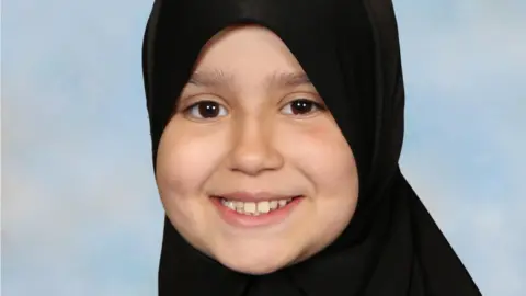 Sara Sharif smiling at the camera. She is wearing a hijab and looking directly at the camera. 