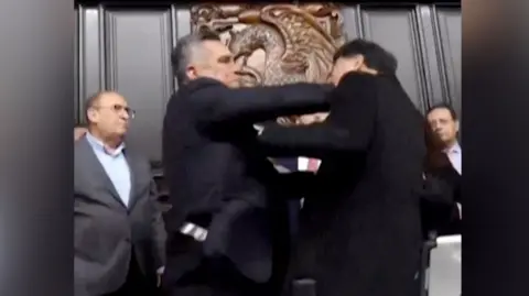 Mexican politicians pushing each other in Senate