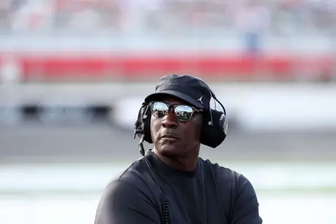 Michael Jordan pictured next to a race car pit at a track in North Carolina
