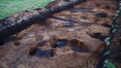An Iron Age roundhouse during excavation.