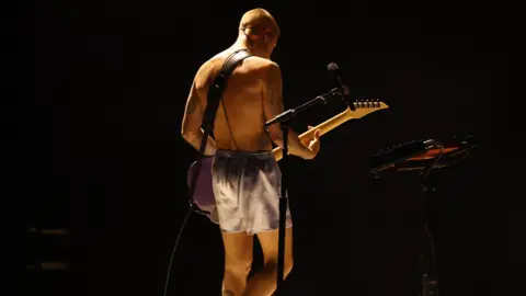 Reuters Justin Bieber playing guitar in only his boxer shorts