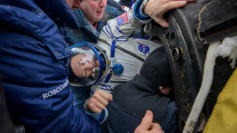 Spacecraft with three astronauts inside is seen returning to Earth.