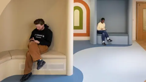 A design interpretation showing the interior of The Sett with two people sitting in booths.