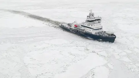 A Polaris class icebreaker designed by Finnish firm Aker Arctic Technology cuts its way through ice covered water