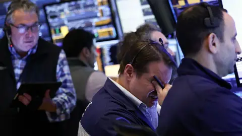 Traders work on the floor of the New York Stock Exchange (NYSE) at the opening bell in New York City, on April 3, 2025.