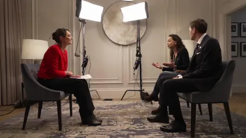 Lucy Hockings interviewing Machado and Frydnes, with big studio lights in the background.