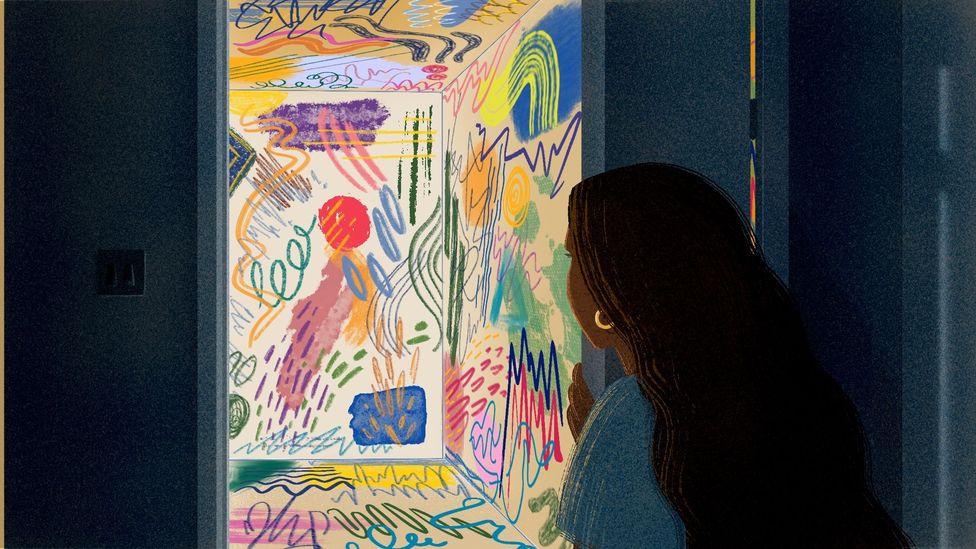 A woman looks at a colourful painting (Credit: Prashanti Aswani)